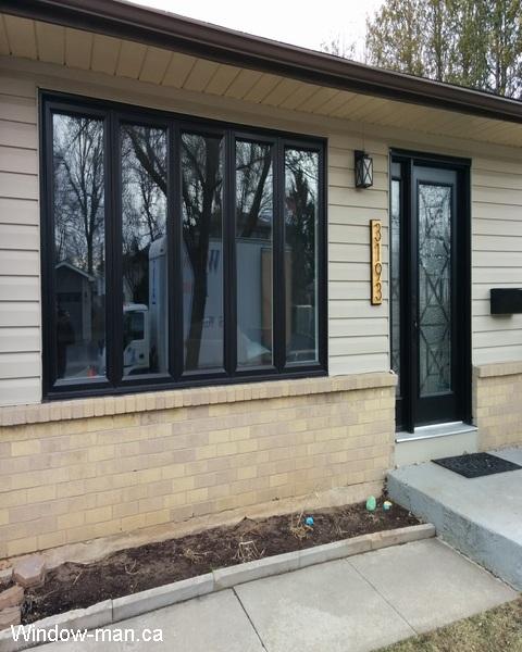 Black front door one sidelight. Black Casements windows. Casement window. Towns bridge iron glass inserts. Professionally installed